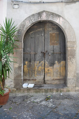 Fototapeta na wymiar Yellow paint wooden door on stone house