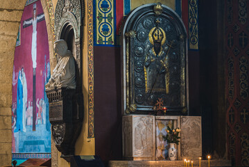 LVIV, UKRAINE - FEBRUARY 10, 2021: Interior of The Armenian Cathedral. Bust of Armenian archbishop Isaak Mikolaj Isakowicz, crucifixion and icon of the Gregory the Illuminator.
