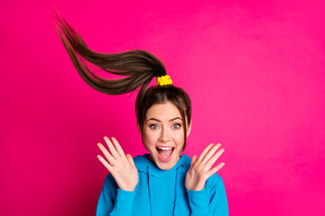 Portrait of attractive impressed lady open mouth arms palms up hair flying isolated on pink color...