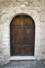 Fototapeta na wymiar Brawn wooden door on stone house
