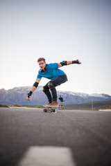 Skateboarder skateboarding on an open road doing freestyle tricks