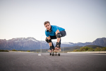 Skateboarder skateboarding on an open road doing freestyle tricks
