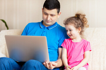 dad and daughter using laptop, watch cartoons educational online program, buying shopping via internet concept. man and girl communicating via Video call with grandparents, friends.