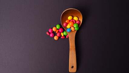 multicolored candy set with a wooden spoon
