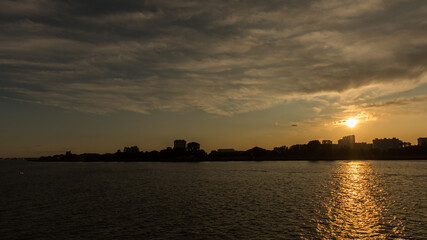 Naklejka premium Sunset over the Scheldt river, in Antwerp, Belgium