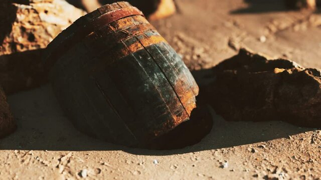 old wooden barrel at sand beach
