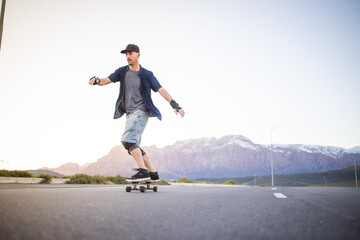 Skateboarder skateboarding on an open road doing freestyle tricks