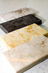 Samples of acrylic stone for kitchen countertops. Close-up, vertical photography.