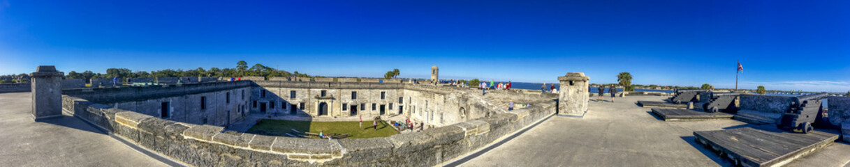 ST AUGUSTINE, FL - FEBRUARY 2016: Tourists along St Marcos Castle on a sunny winter day - Panoramic view