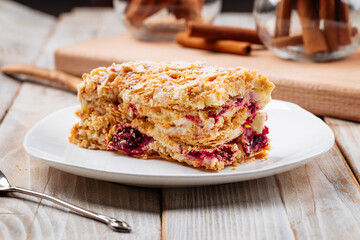 Closeup on berry shortbread dough pie slice on the wooden background
