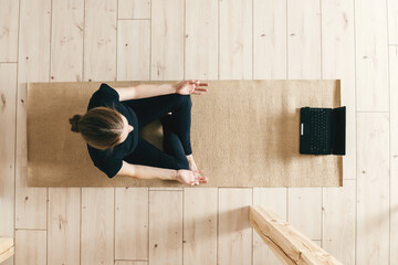 Top view of woman woman practicing yoga indoor.