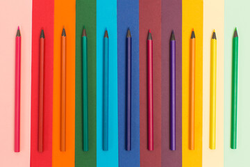Many multicoloured pencils on colourful background