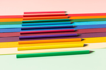 Many multicoloured pencils on colourful background