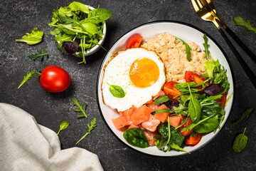 Savory breakfast with oatmeal, salmon and salad.