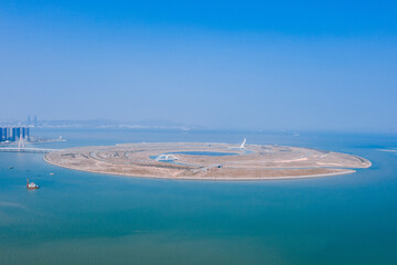 Aerial view of an artificial island on the sea against blue sky and ocean, the Double Happiness Island at the coastline between Xiamen and Zhangzhou in Fujian, China