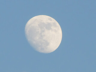 full moon in the daytime sky