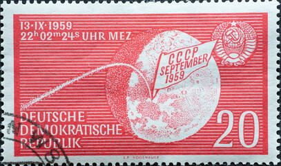  the Earth moon with stylized trajectory of Lunik 2, impact date and USSR national coat of arms....