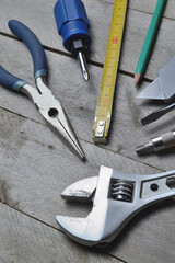 some home repair tools lie on a wooden background. close-up.