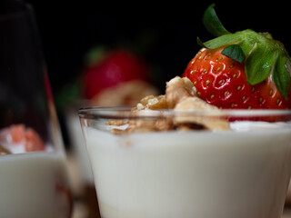 Natural and healthy dessert of yogurt, honey, strawberries and walnuts