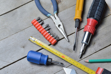 some home repair tools lie on a wooden background. close-up.