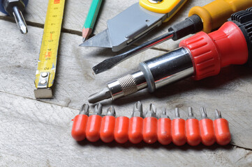 some home repair tools lie on a wooden background. close-up.