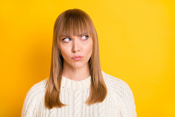 Photo of unsatisfied person pouted lips look empty space wear knitted sweater isolated on yellow...