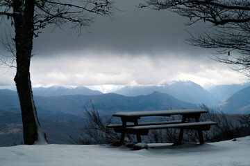Table and bench in the mountains in winter