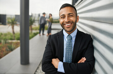 Handsome young business college student smiling with hands crossed