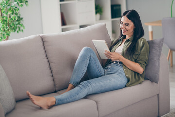Full length profile side photo of young attractive woman happy positive smile write notebook plan to-do list couch indoors