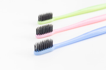 Colorful toothbrushes on a white background. Close-up. Soft Focus