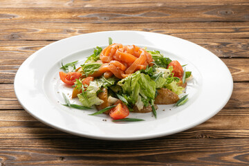 Vegetarian vegetable salad with salmon, potatoes and cherry tomatoes