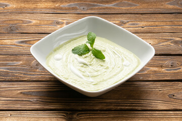 Vegetarian spinach cream soup with yogurt and mint leaves