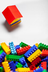 A colorful constructor set with the little house made from designer blocks close-up on the white background