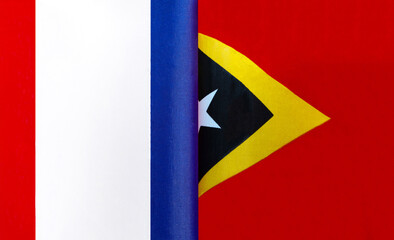 fragments of the national flags of France and the Democratic Republic of East Timor close-up