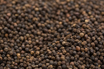 Black pepper corns on black background