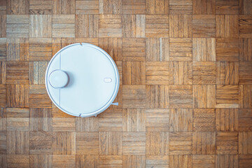 Robot vacuum cleaner performs automatic cleaning of the apartment at a certain time. Smart home....