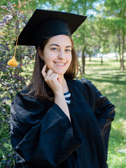 Girl student looks into the frame of the lens. Bachelor's degree defense at the university.