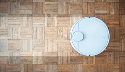 robotic vacuum cleaner on laminate wood floor smart cleaning technology. Robotic vacuum cleaner...