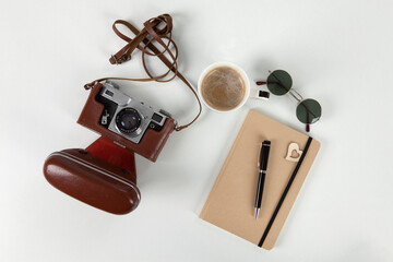 Analog camera, notebook and sunglasses