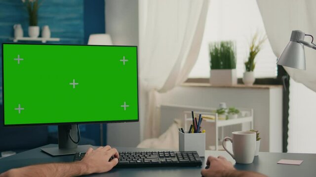 Pov of man hands sitting on office desk using computer with mock up green screen chroma key working