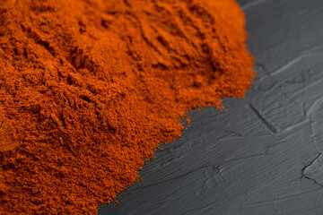 Red chili peppers powder on black