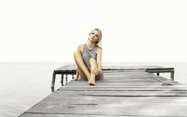 Fototapeta na wymiar sexy blonde woman in lingerie posing on the coast. summer on the beach