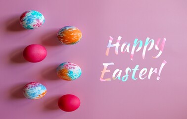 Colorful hand-painted Easter eggs on pink background. Text: Happy Easter! 