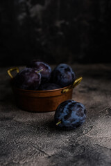 Couple of plums on the dark background