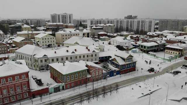 The Old-Tatar Quarter Sloboda settlement in Kazan. Old wooden houses with mosque Tatarstan. Winter snow. Aerial view. Flying over. Drone is moving left and back