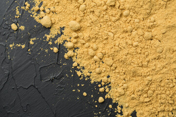 Mustard powder on black background