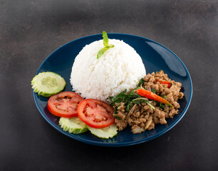 Thai Food Rice topped with stir-fried pork and basil.