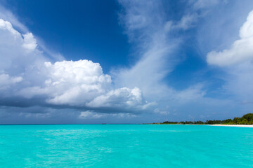 tropical Maldives island with white sandy beach and sea