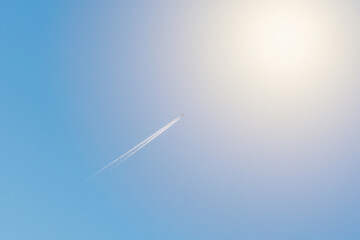 Small Airplane and trail across the blue sky