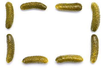 . Frame from fresh pickled cucumbers of unequal seeds on a white background. Template for the designer